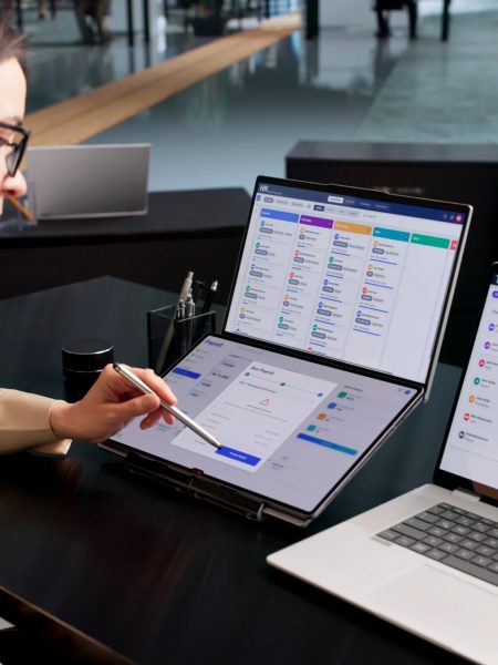 Woman In Office Uses Payroll Software To Track Employee Salary And Benefits.