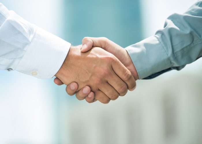 Close-up image of a firm handshake standing for a trusted partnership